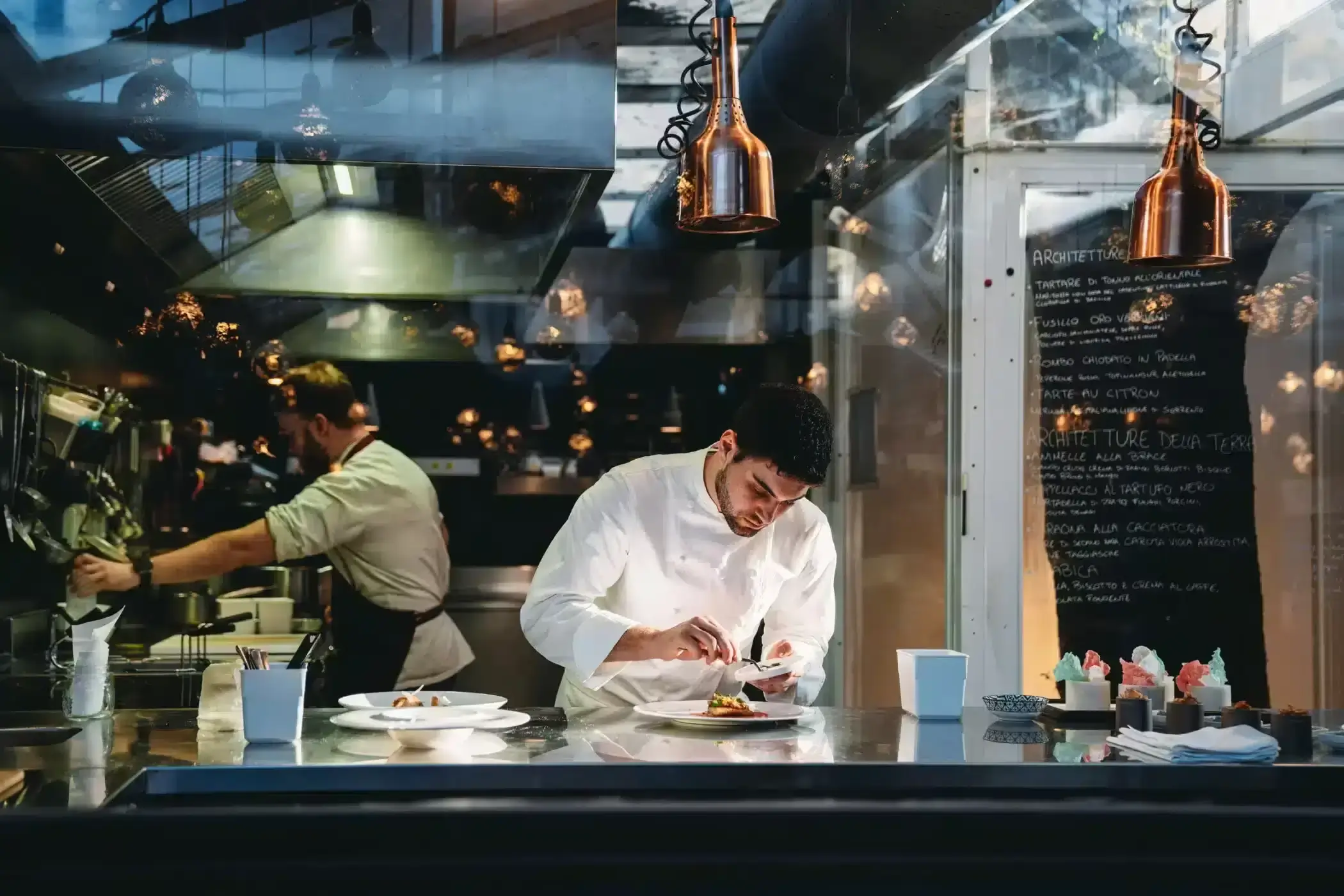 A hospitality professional at work in a professional kitchen